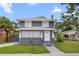 Charming two-story home featuring a gray exterior, white trim, and well-maintained front yard at 2312 Highland S St, St Petersburg, FL 33705