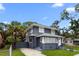 Lovely two-story home featuring a gray exterior, white trim, and lush landscaping at 2312 Highland S St, St Petersburg, FL 33705