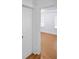 Hallway looking into a bedroom with white trim and walls and wood floors at 2312 Highland S St, St Petersburg, FL 33705