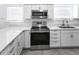 Well-lit kitchen with stainless steel appliances, white cabinetry, and granite countertops at 2312 Highland S St, St Petersburg, FL 33705