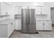 Bright kitchen features white cabinets, granite countertops, and stainless steel refrigerator at 2312 Highland S St, St Petersburg, FL 33705