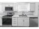Modern kitchen with stainless steel appliances, including microwave, oven, and dishwasher at 2312 Highland S St, St Petersburg, FL 33705