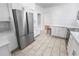 Updated kitchen with white cabinetry, stainless steel refrigerator, and modern countertops at 2312 Highland S St, St Petersburg, FL 33705