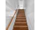 Bright staircase features wood treads, white risers and walls, and a wood railing leading upstairs at 2312 Highland S St, St Petersburg, FL 33705