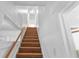 Bright staircase features wood treads, white risers and walls, and a wood railing leading upstairs at 2312 Highland S St, St Petersburg, FL 33705