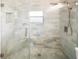 Modern bathroom features a walk-in shower with marble tiling and a glass enclosure at 2315 E 12Th Ave, Tampa, FL 33605