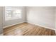 Bedroom featuring a window with wood flooring, a neutral color and an electrical outlet at 2315 E 12Th Ave, Tampa, FL 33605