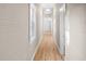 Long hallway features wood floor, light colored walls, white trim and several windows at 2315 E 12Th Ave, Tampa, FL 33605
