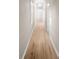 Long hallway with light colored walls, wood floor, baseboard and windows along the wall at 2315 E 12Th Ave, Tampa, FL 33605