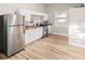 Bright kitchen featuring white cabinets, stainless steel appliances and wood-look flooring at 2315 E 12Th Ave, Tampa, FL 33605