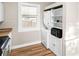 Convenient laundry area includes a washer and dryer and storage cabinet at 2315 E 12Th Ave, Tampa, FL 33605