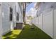 Backyard with green artificial turf, white fence, and space for activities at 2519 1St N Ave, St Petersburg, FL 33713