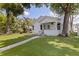 Inviting home showcasing lush landscaping, a cheerful front porch, and a freshly cut lawn at 2519 1St N Ave, St Petersburg, FL 33713