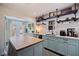Charming kitchen featuring shaker cabinets, butcher block island, and open shelving at 2519 1St N Ave, St Petersburg, FL 33713