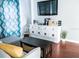 Charming living room with modern console, hardwood floors, and bright curtains at 2519 1St N Ave, St Petersburg, FL 33713