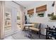 Cozy sunroom with a bench, small table, windows, and access to the outdoor space at 2519 1St N Ave, St Petersburg, FL 33713