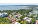 Aerial view of a residential community with mature trees, parking, and bay views at 2630 Pearce Dr # 108, Clearwater, FL 33764