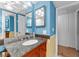 Bright bathroom with granite vanity, dual mirrors and cabinets with gold accents at 2630 Pearce Dr # 108, Clearwater, FL 33764