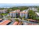 Exterior of a residential building featuring multiple stories, a red roof, and mature landscaping at 2630 Pearce Dr # 108, Clearwater, FL 33764