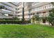 Exterior view of multi-story building with tropical landscaping and white balconies at 2630 Pearce Dr # 108, Clearwater, FL 33764