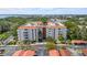 Multi-story condominium with red tile roof and covered parking nestled amongst mature, lush landscaping at 2630 Pearce Dr # 108, Clearwater, FL 33764