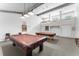 Community game room with two billiard tables, a cue rack, and a seating area at 2630 Pearce Dr # 108, Clearwater, FL 33764