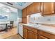Kitchen featuring white appliances, wooden cabinetry, white tiled backsplash and blue ceiling at 2630 Pearce Dr # 108, Clearwater, FL 33764