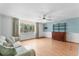 Comfortable living room featuring a large window with decorative curtains at 2630 Pearce Dr # 108, Clearwater, FL 33764