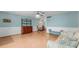 Open floor plan living room with laminated floor and comfortable furnishings at 2630 Pearce Dr # 108, Clearwater, FL 33764
