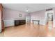 Bright living room featuring light pink walls, wood floors, a ceiling fan, and a doorway to another room at 2630 Pearce Dr # 108, Clearwater, FL 33764