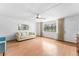 Spacious living room with neutral walls, laminated floors and a ceiling fan at 2630 Pearce Dr # 108, Clearwater, FL 33764