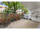 Charming outdoor patio with a brick wall, lush landscaping, and a view of the surrounding building at 2630 Pearce Dr # 108, Clearwater, FL 33764