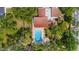 Aerial view of community pool with lounge chairs and mature landscaping at 2630 Pearce Dr # 108, Clearwater, FL 33764
