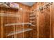 Spacious walk-in closet with wood paneling and multiple shelving units for ample storage at 2630 Pearce Dr # 108, Clearwater, FL 33764