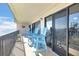 Relax on this condo's tiled balcony featuring charming Adirondack chairs and views of the waterfront at 2700 Bayshore Blvd # 11308, Dunedin, FL 34698