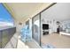 Bright condo balcony featuring comfortable Adirondack chairs and views into the living area at 2700 Bayshore Blvd # 11308, Dunedin, FL 34698