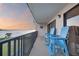 Enjoy the tranquil waterfront views from this condo's balcony with Adirondack chairs as the sun sets at 2700 Bayshore Blvd # 11308, Dunedin, FL 34698