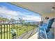 Inviting balcony with seating overlooks a grassy area and calm waters at 2700 Bayshore Blvd # 11308, Dunedin, FL 34698