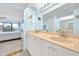 Bright bathroom features a dual sink vanity, and a view into the bedroom with sliding doors to the balcony at 2700 Bayshore Blvd # 11308, Dunedin, FL 34698