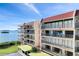 Condo exterior with multiple balconies offering waterfront views and private outdoor seating areas at 2700 Bayshore Blvd # 11308, Dunedin, FL 34698