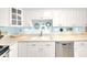 Well-lit kitchen with white cabinets, modern stainless steel appliances, and a stylish backsplash at 2700 Bayshore Blvd # 11308, Dunedin, FL 34698