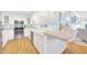 Open-concept kitchen featuring stainless steel appliances, white cabinets, and a breakfast bar overlooking the living area at 2700 Bayshore Blvd # 11308, Dunedin, FL 34698