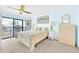 Bright main bedroom featuring water views, a ceiling fan, and neutral-toned decor at 2700 Bayshore Blvd # 11308, Dunedin, FL 34698