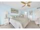 Bright main bedroom with water views, a ceiling fan, and calming blue walls at 2700 Bayshore Blvd # 11308, Dunedin, FL 34698
