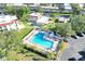 Aerial view of the community pool surrounded by lounge chairs and tropical landscaping at 2700 Bayshore Blvd # 11308, Dunedin, FL 34698