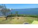 Water view from backyard, lush greenery, and nearby watercraft create a serene outdoor setting at 2700 Bayshore Blvd # 11308, Dunedin, FL 34698
