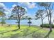 Scenic grassy area with picnic tables overlooking the tranquil water and passing boats at 2700 Bayshore Blvd # 11308, Dunedin, FL 34698
