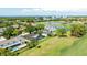 Expansive aerial view of the home, golf course, ponds, and nearby city at 2900 Sandpiper Pl, Clearwater, FL 33762
