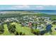 An overhead view shows the property with golf course, waterways, and an airport in the distance at 2900 Sandpiper Pl, Clearwater, FL 33762