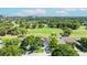 Aerial view showcasing the home's proximity to a golf course and lush surroundings at 2900 Sandpiper Pl, Clearwater, FL 33762